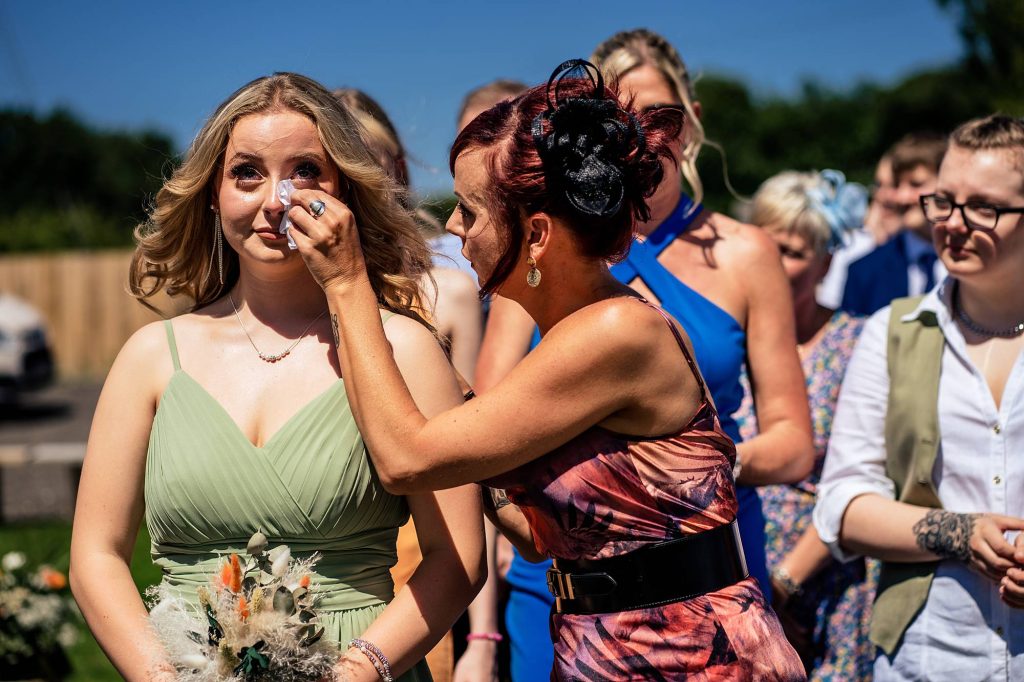 Bridesmaid shedding a tear