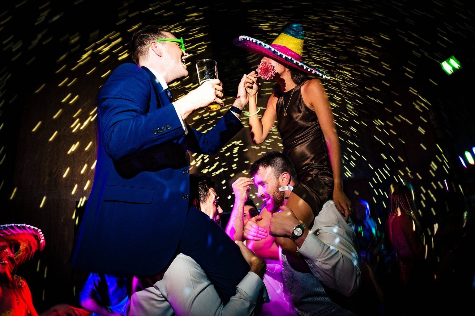 couple on the shoulders during the party